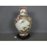 A large vase decorated with panels of birds against a millefiori ground,