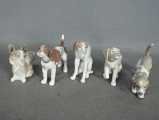 Lladro - Five Ceramic Dog Figures. Tallest is 10cm high.