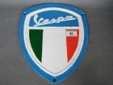 A cast sign marked Vespa,