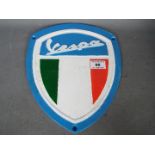 A cast sign marked Vespa,