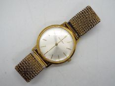 An 18ct gold cased Walker & Hall ultra slim wristwatch, the case back marked 2502G,