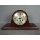 A mahogany cased mantel clock, the silvered dial with Arabic numerals and marked Hy.