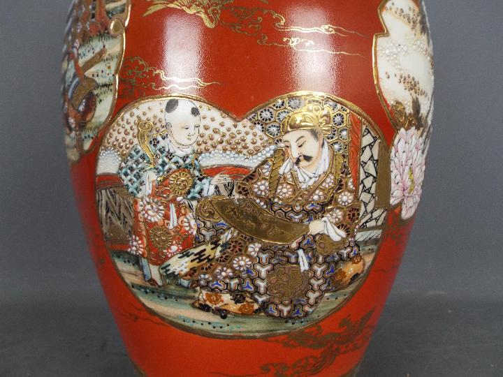 A large Japanese vase decorated with panels of samurai, scholars, flowers against a red ground, - Image 2 of 9