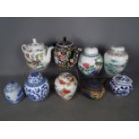 A collection of Chinese teapots and ginger jars.