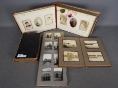 A late 19th century embossed leather photograph album with photographs,