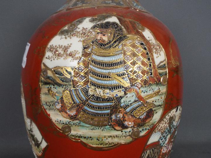 A large Japanese vase decorated with panels of samurai, scholars, flowers against a red ground, - Image 4 of 9