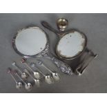 A George V hallmarked silver dressing table hand mirror, a similar white metal example,