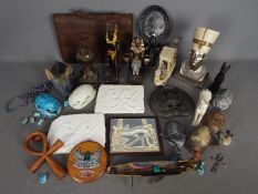 A collection of Egyptian style objects, carved scarabs, ornaments and similar.