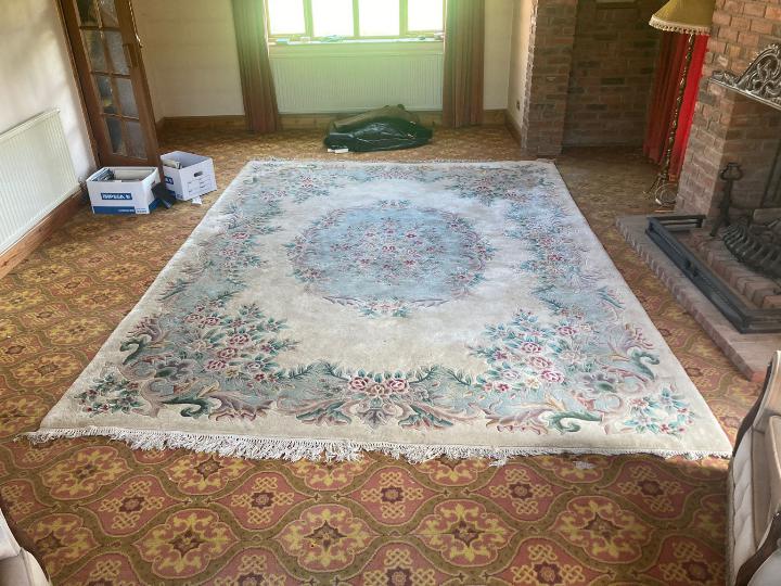 A large rug with floral decoration on a cream ground, approximately 370 cm x 110 cm. - Image 3 of 3