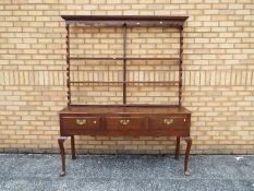 A George III style kitchen dresser with three drawers to the base,