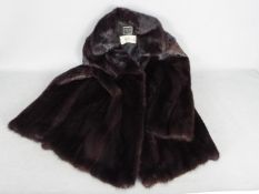 A Finnish Saga Mink fur jacket in a dark chocolate brown colour, slip pockets,