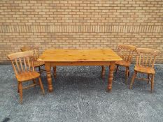 A rectangular topped pine kitchen table and four chairs, table approximately 77 cm x 160 cm x 86 cm.