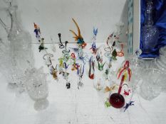 Coloured and crystal clear glass collection. Including merry go round and bird cage.