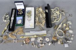 A collection of costume jewellery and watches.