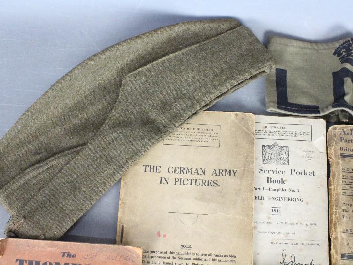 A collection of military items to include a World War Two (WW2 / WWII) defence medal with slip in - Image 8 of 8