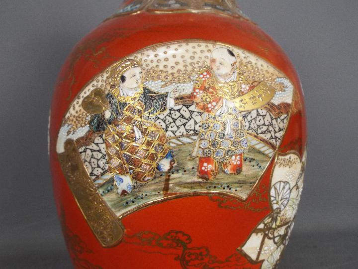 A large Japanese vase decorated with panels of samurai, scholars, flowers against a red ground, - Image 5 of 9
