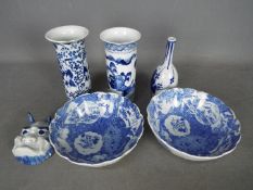 A collection of blue and white ceramics to include vases, bowls and a small horned mask.