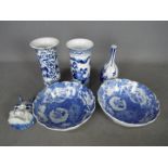 A collection of blue and white ceramics to include vases, bowls and a small horned mask.