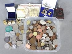 A collection of coins and a small quantity of banknotes,