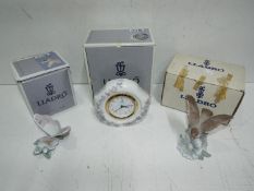 Lladro - Two figures boxed and a clock also boxed and working.