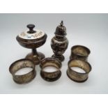 Lot to include a small silver pepperette, four silver napkin rings, varying assay and date marks,