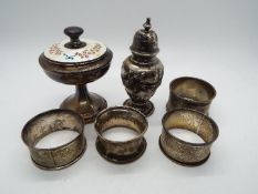 Lot to include a small silver pepperette, four silver napkin rings, varying assay and date marks,