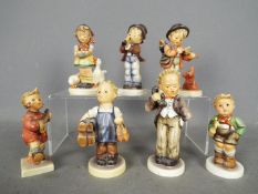Seven Hummel figurines to include Boy With Telephone, Boy With Violin, Boy With Trumpet,