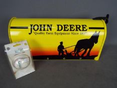 A novelty US style John Deere mail / post box, approximately 25 cm x 48 cm x 18 cm and a baseball.