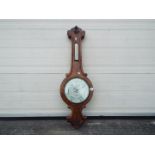 An Abraham & Co Liverpool banjo barometer with carved detailing to the case,