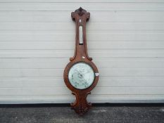 An Abraham & Co Liverpool banjo barometer with carved detailing to the case,