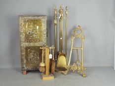 A brass fireside companion set, a smaller set and a brass bound umbrella or stick stand.