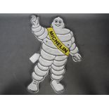 A cast iron Michelin man wall plaque,