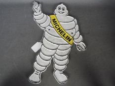 A cast iron Michelin man wall plaque,