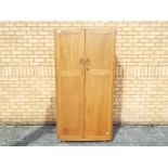 An Ercol twin door wardrobe measuring approximately 183 cm x 91 cm x 55 cm,