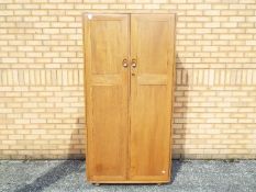 An Ercol twin door wardrobe measuring approximately 183 cm x 91 cm x 55 cm,