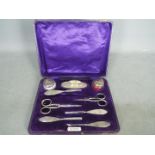 A George V hallmarked silver grooming set in fitted case, Birmingham assay 1919,