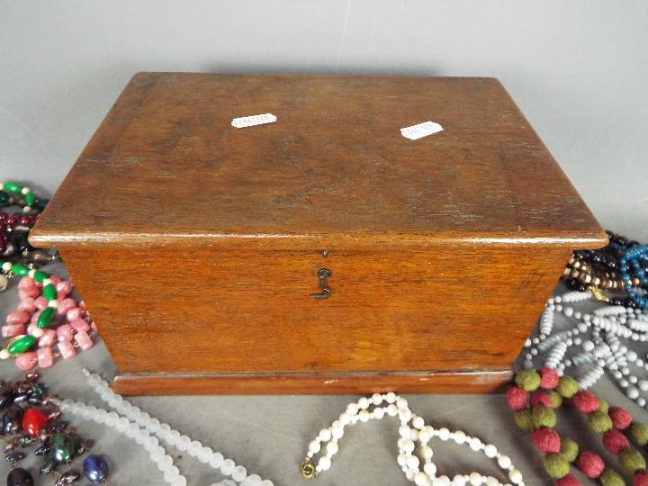 A wooden box containing a quantity of costume jewellery. - Image 8 of 8