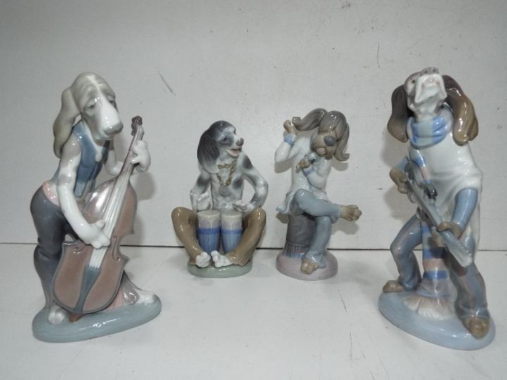 Lladro - Dog Band - Four figures of dogs playing instruments. Tallest is 23cm high.