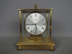 A brass and glass cased Kundo Electronic clock by Kieninger & Obergfell,