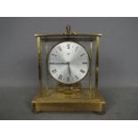 A brass and glass cased Kundo Electronic clock by Kieninger & Obergfell,