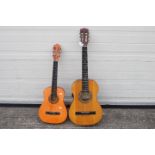 Two child's acoustic guitars, one by Encore and one other.
