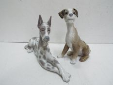 Lladro Two Dog figures. Blue factory marks and impressed numbers. Tallest 20cm high.