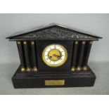 A mantel clock of architectural form wit