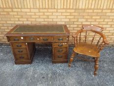 A kneehole desk with leather insert to t