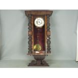 A mahogany cased wall clock with pendulu