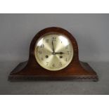 An oak cased Napoleons hat mantel clock