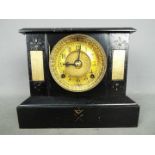 A cast iron cased mantel clock by Ansoni