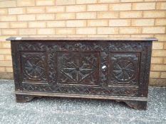 A highly carved chest measuring approxim