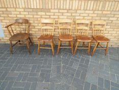 Five chairs comprising a captains chair and four kitchen chairs.