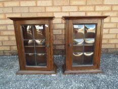 A small pair of cupboards with leaded gl